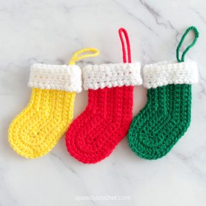 Yellow, red and green mini Christmas stockings.