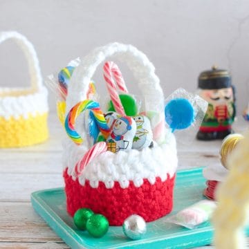 Red crochet basket fill with Christmas treats.