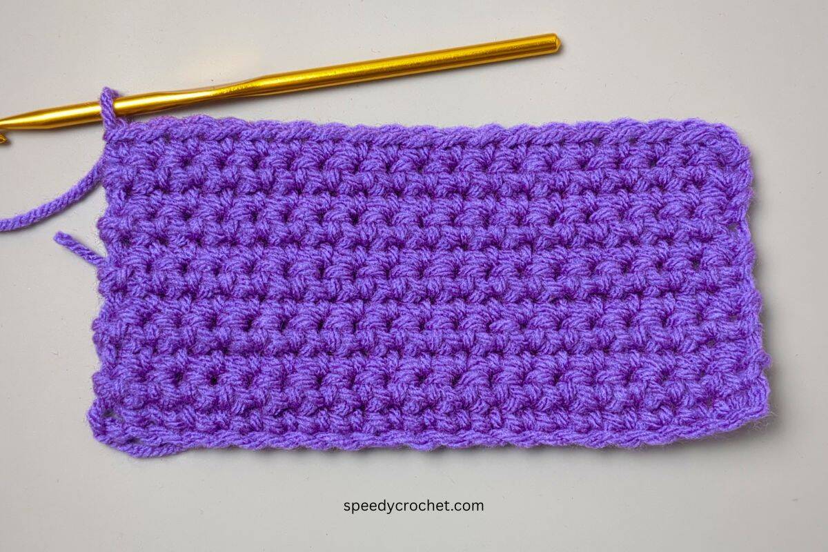 A purple crochet swatch made with single crochet stitches.