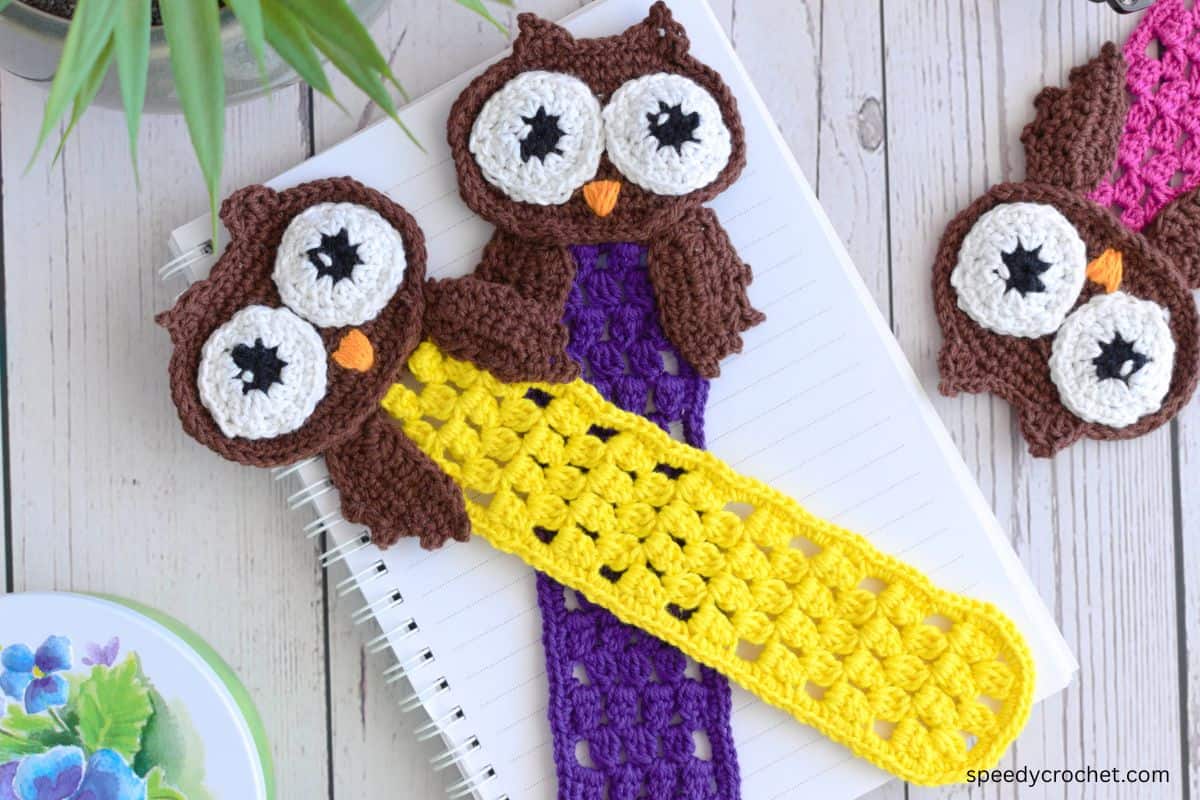 Closeup of a yellow owl bookmark.