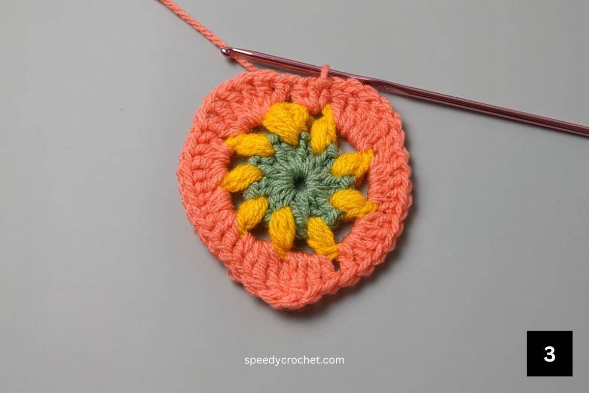 Three rounds of an incomplete crochet heart.