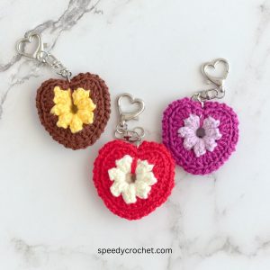 Three crochet heart keychains.