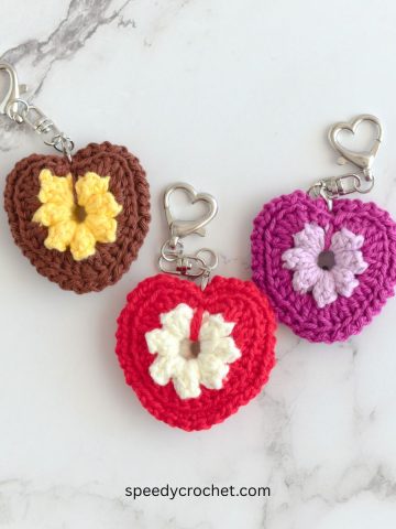 Three crochet heart keychains.