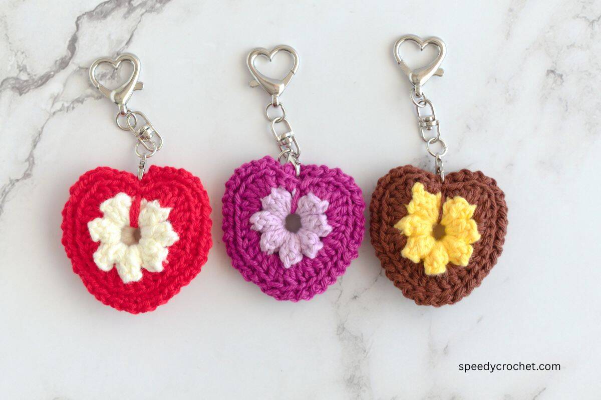 Crochet keychains in the colors, red, purple and brown.
