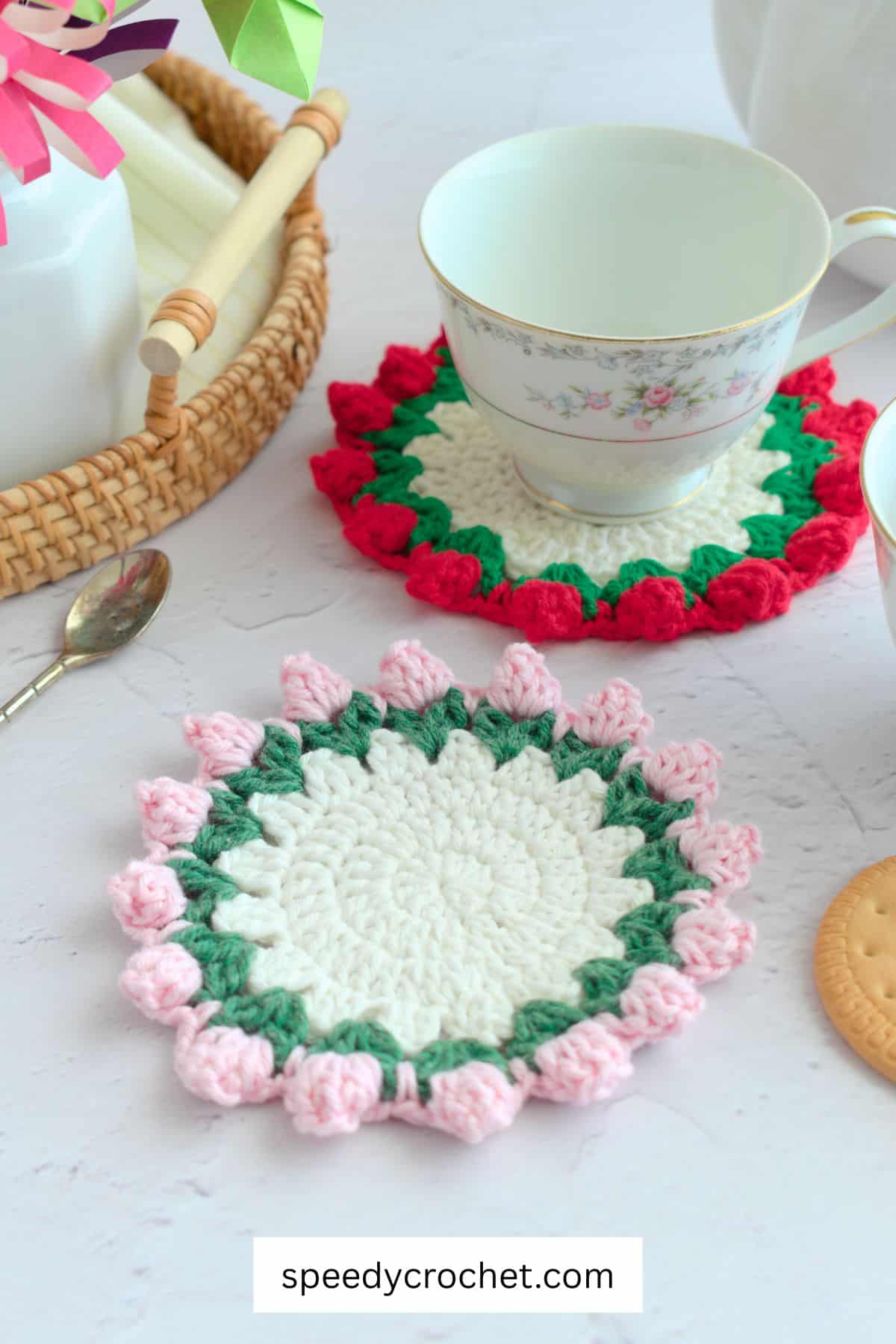 Crochet coasters with pink and red edging.