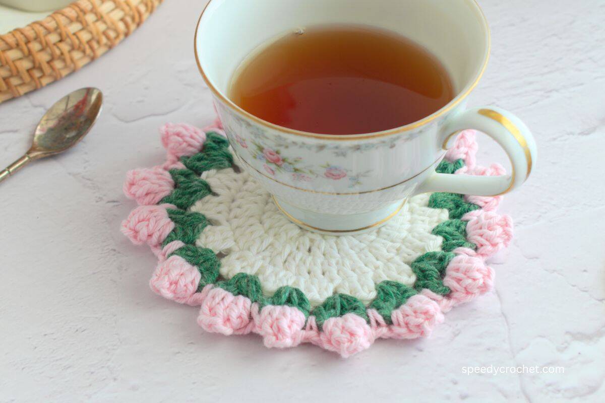 Pink and white coaster and tea cup.
