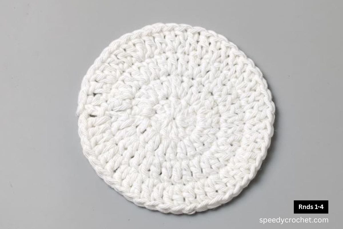 A white 4 round crochet circle.