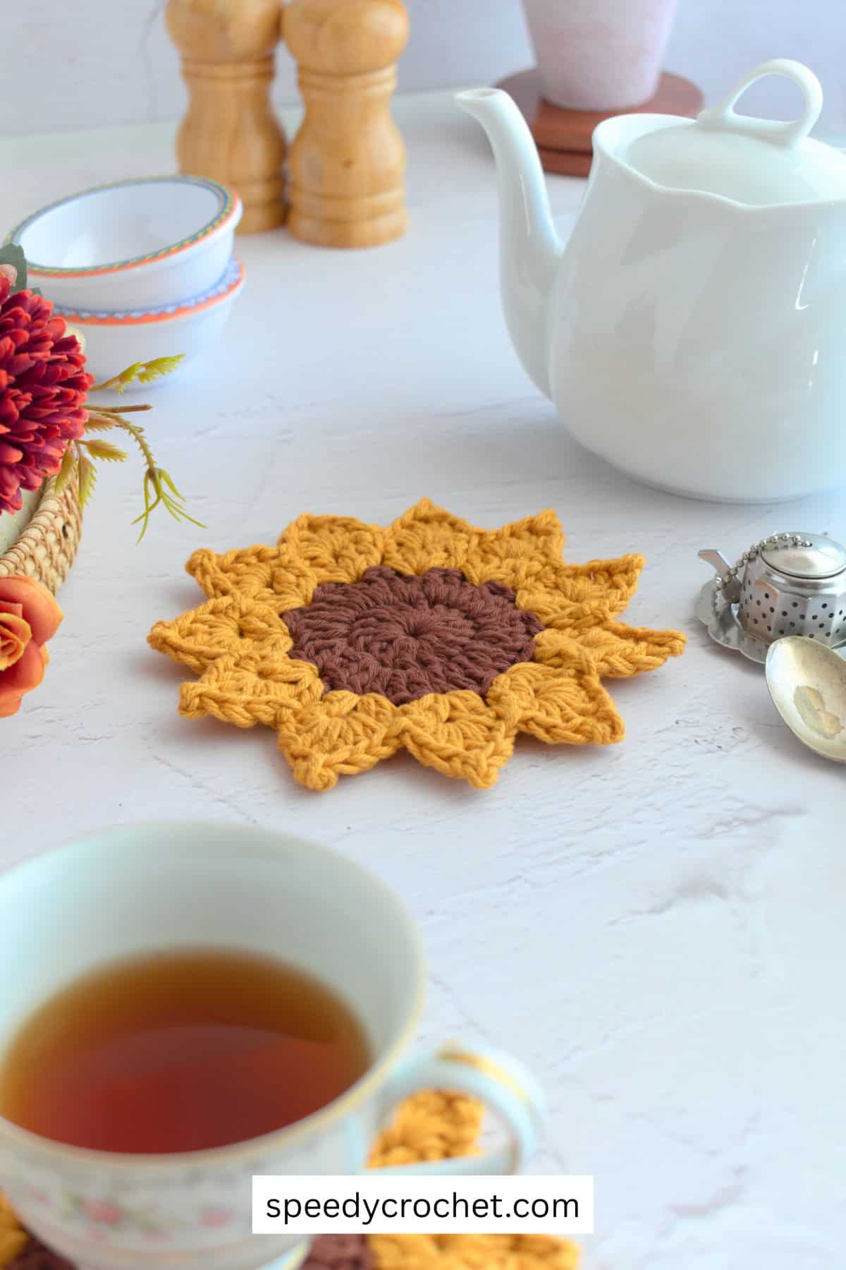 A sunflower coaster on a table.
