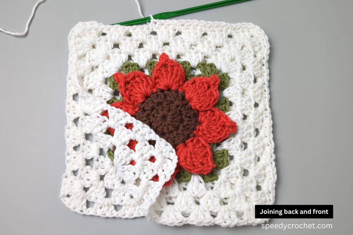 Two granny squares with joined together with a single crochet edge.