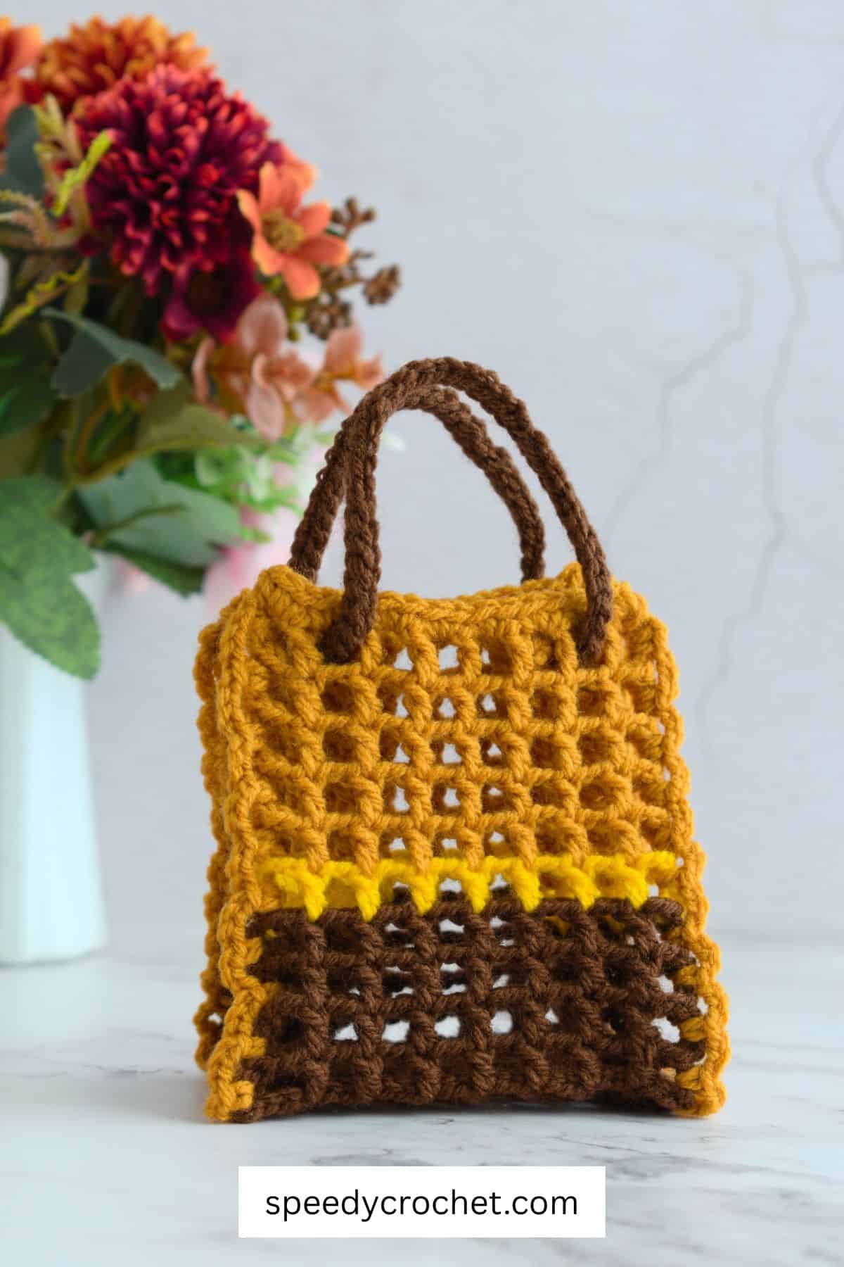 Brown and gold crochet mesh gift bag.