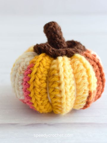 Multi colored ribbed crochet pumpkin.