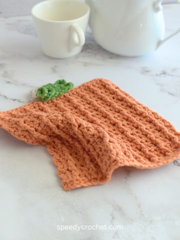 Orange crochet dishcloth.